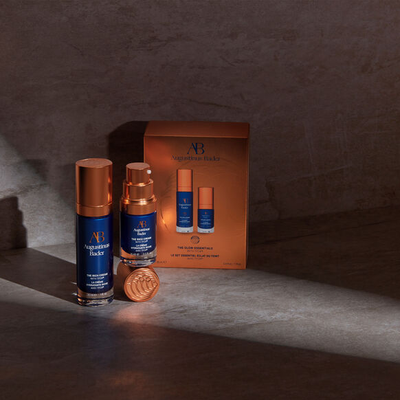 Augustinus Bader The Glow Essentials skincare set with blue and copper bottles and box
