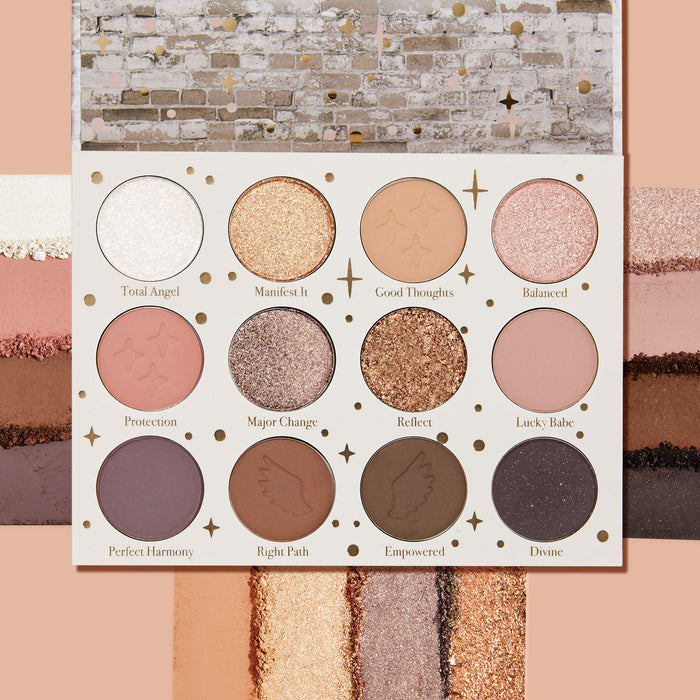 11:11 ColourPop Shadow Palette opens to 12 pans in a white case with gold stars, showing warm neutrals and pinks in matte and glittery metallic finishes, with crushed swatches above and below on a peach backdrop; shades include Reflect and Divine.