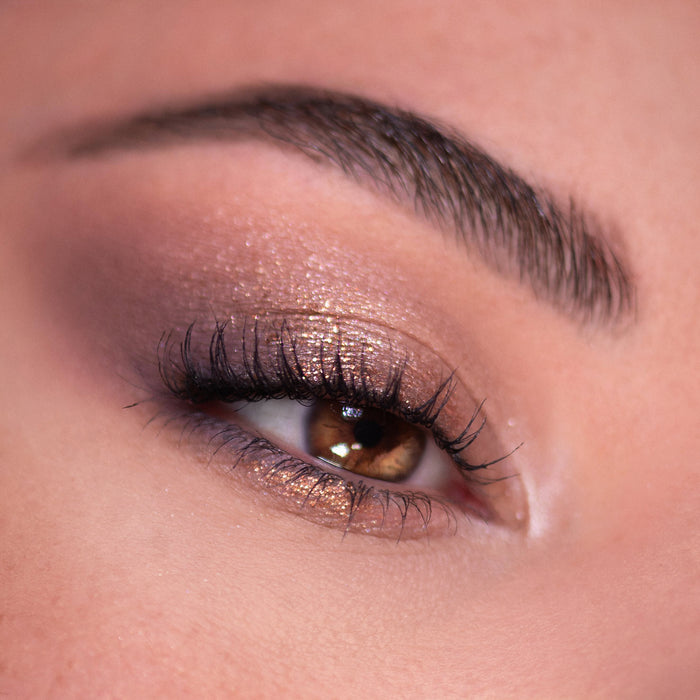 Glittering bronze and mauve eyeshadow blends on a brown eye with fluttery lashes and a groomed brow, created using the 11:11 Shadow Palette, a ColourPop Shadow Palette delivering day-to-night metallic sparkle.