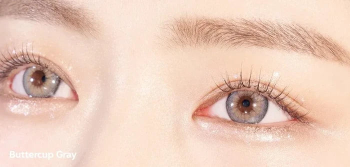 A close-up of a model demonstrating a natural makeup look with Ann365 Buttercup Grey circle colour contacts, highlighting how well the contact lenses blend with her dark eyes.