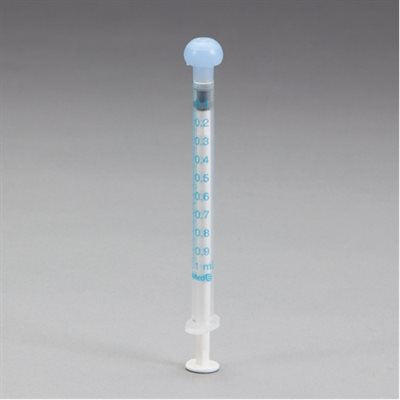 A 1 ml oral syringe stands upright on a flat surface. The syringe is clear with blue markings indicating milliliter measurements from 0.1 ml to 1 ml.