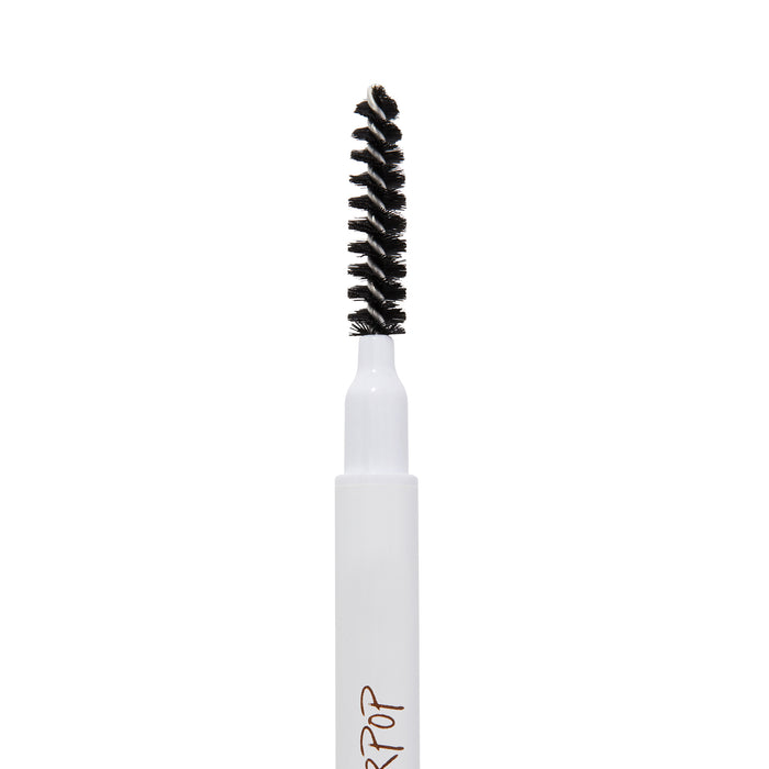 ColourPop Black N' Brown Pencil brow pencil spoolie brushing and shaping eyebrows, close-up of black spiral bristles on a white barrel with partial logo, isolated on a white background.