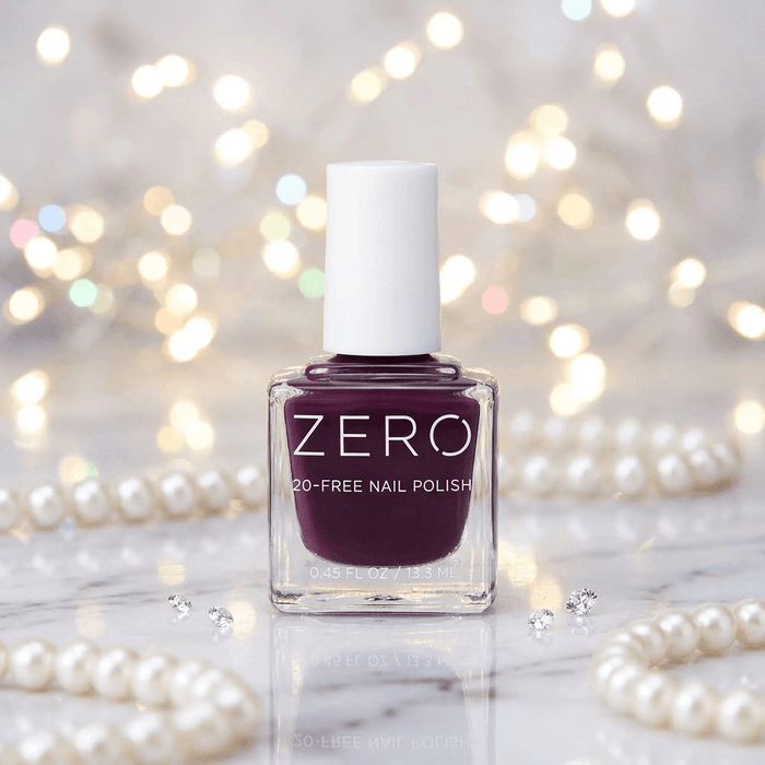 Bottle of ZERO nail polish with a blurred background of lights and pearls