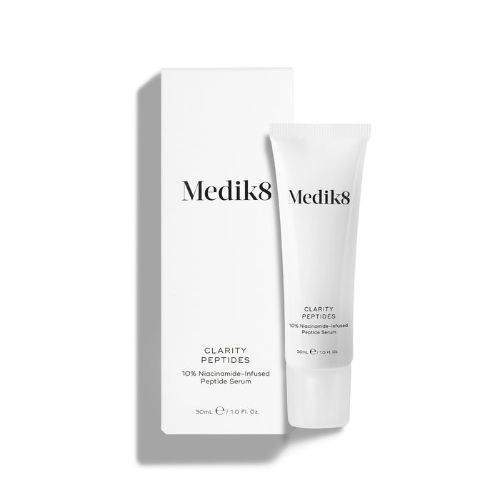 Medik8 Clarity Peptides tube stands next to its white packaging carton on a white background. Text identifies it as a "10% Niacinamide-Infused Peptide Serum" in a 30mL size.
