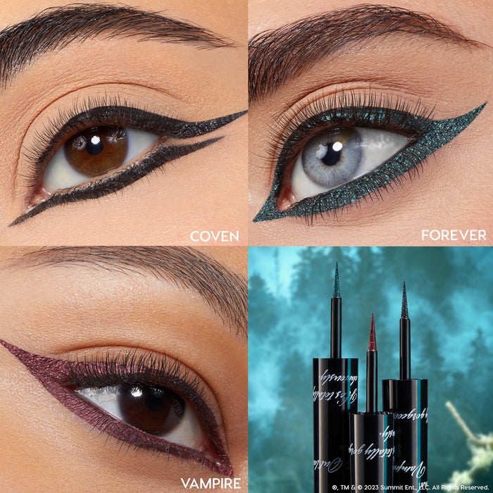 Coven shade of ColourPop Graphix Ink Liner creates a sharp double wing in black shimmer on a brown eye; adjacent panels show Forever teal and Vampire burgundy looks, with three precision brush-tip pens set before a misty forest backdrop.