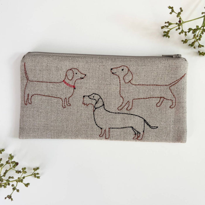 Small linen pouch with zipper, gray fabric, red dachshund embroidery pattern.
