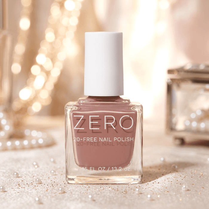 Bottle of ZERO nail polish with a soft pink color on a blurred background