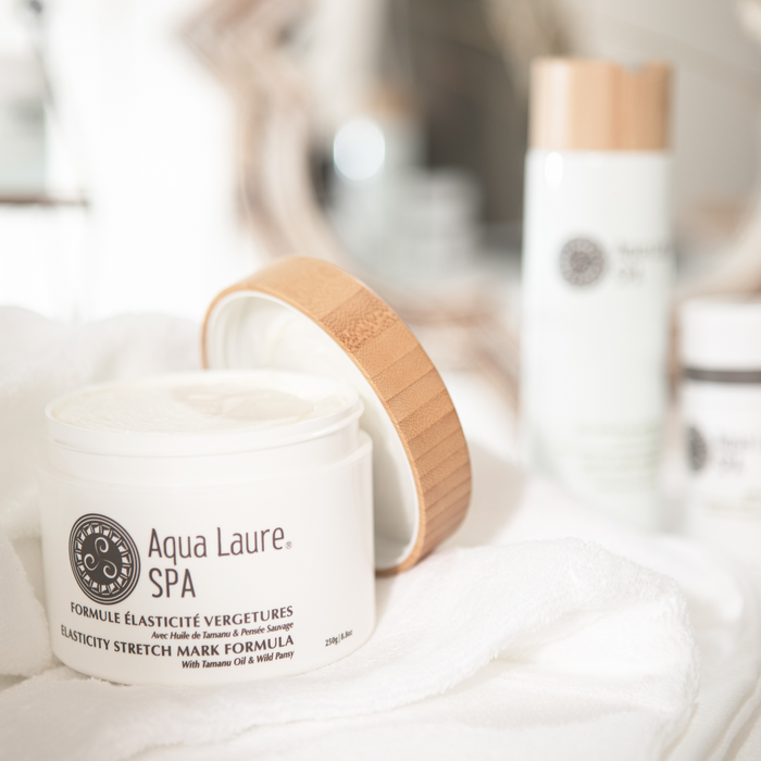 Aqua Laure SPA Elasticity Stretch Mark Formula jar with bamboo lid, featuring Tamanu Oil & Wild Pansy, displayed on soft white towel