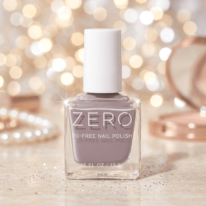 Bottle of ZERO nail polish with a blurred festive background