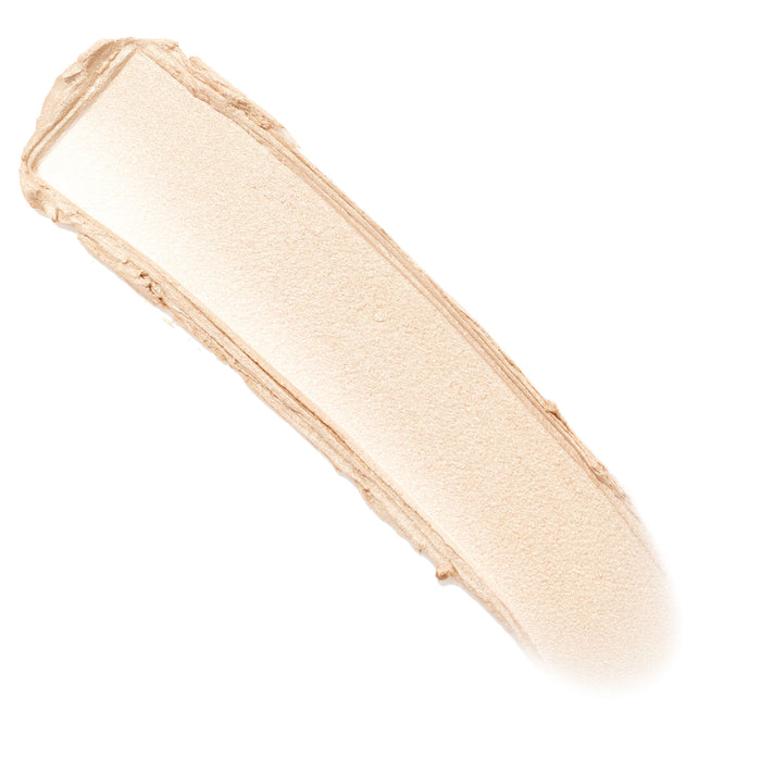 Glazey ColourPop Lite Stix swatch swept diagonally on a white background, revealing a creamy champagne‑beige stripe with fine pearly shimmer and soft edges, showing the stick highlighter’s smooth payoff and luminous finish.