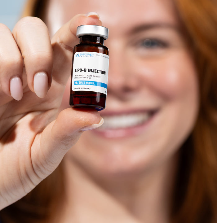 Person holding a small bottle labeled 'Lipo-B Injection' with a blurred background