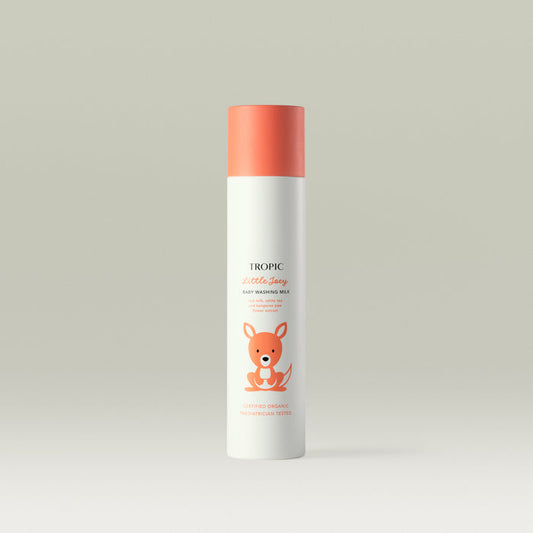 Tropic Little Joey Baby Washing Milk bottle with coral-orange cap and cute kangaroo illustration on a light background. Text mentions oat milk, white tea, and kangaroo paw flower extract.