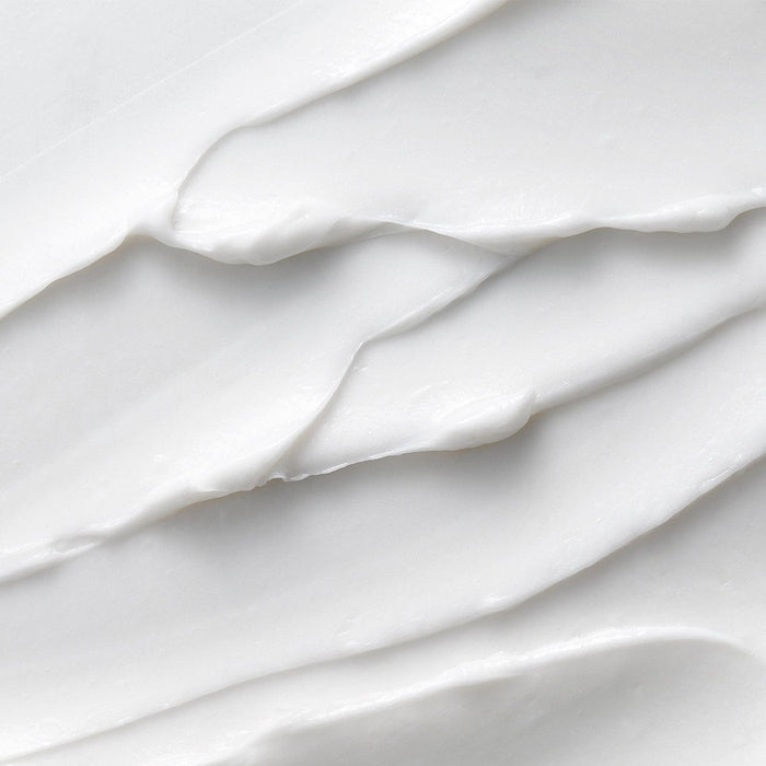 Smooth white creamy texture of Tropic Look Sharp Sensitive Shave, showcasing its rich, velvety consistency that cushions and hydrates the skin during shaving.