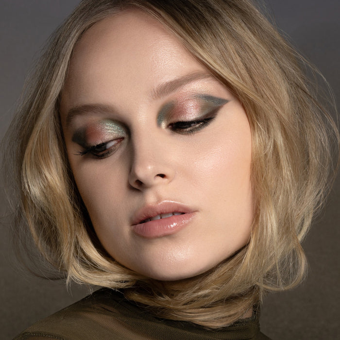 Mini Gloom Palette inspired model look on a dark green background.