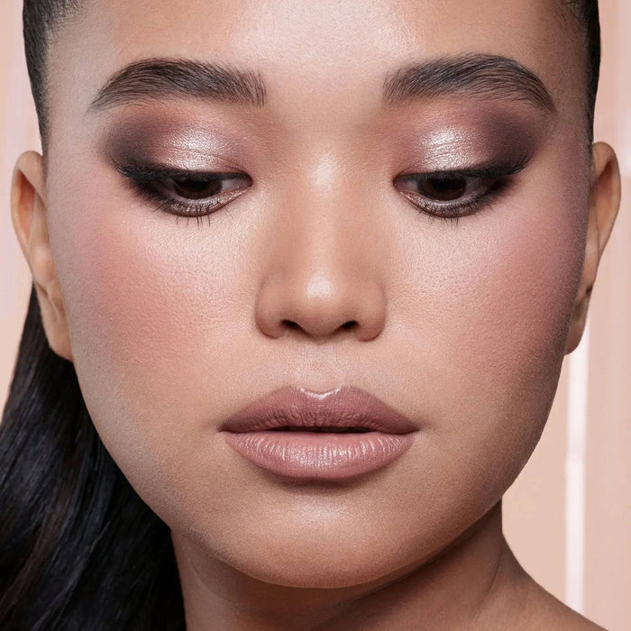 My Mini Dream Eyeshadow Palette model look on a light pink background.