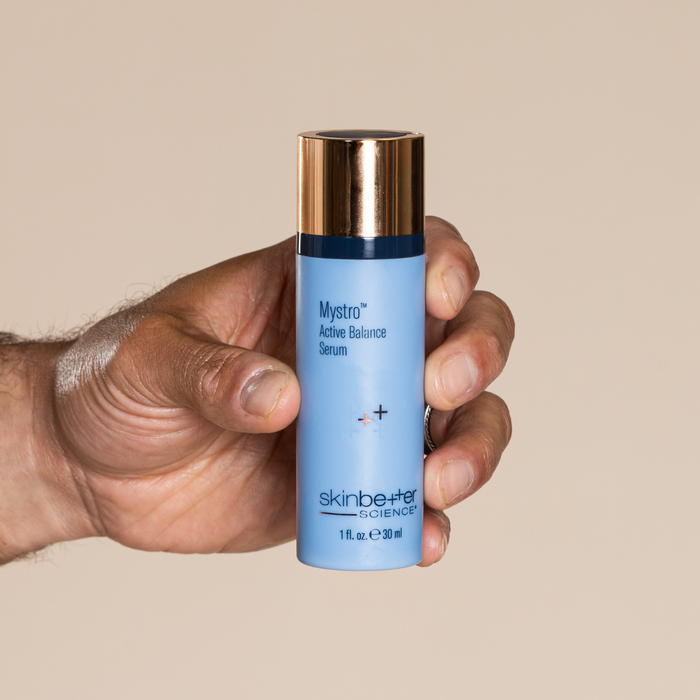 Close-up of a person's hand with skin better's mystro product