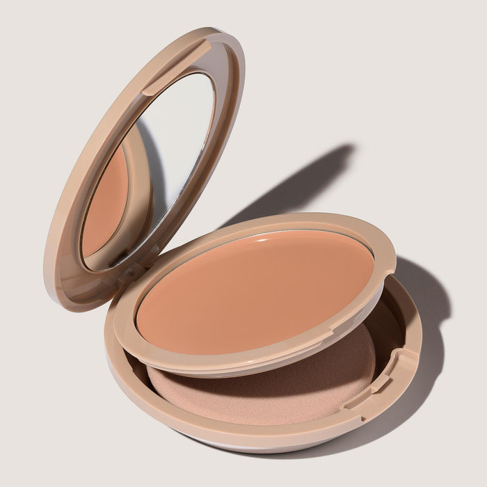 An open FlexShade Foundation by No Makeup Makeup compact in Almond showing the sponge compartment