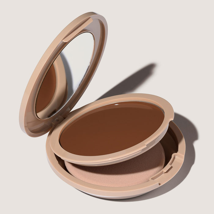 An open FlexShade Foundation by No Makeup Makeup compact in Dark showing the sponge compartment