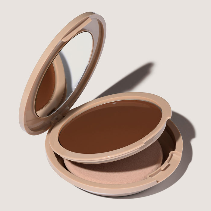 An open FlexShade Foundation by No Makeup Makeup compact in Deep showing the sponge compartment