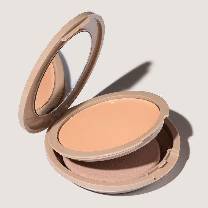 An open FlexShade Foundation by No Makeup Makeup compact in Fair showing the sponge compartment