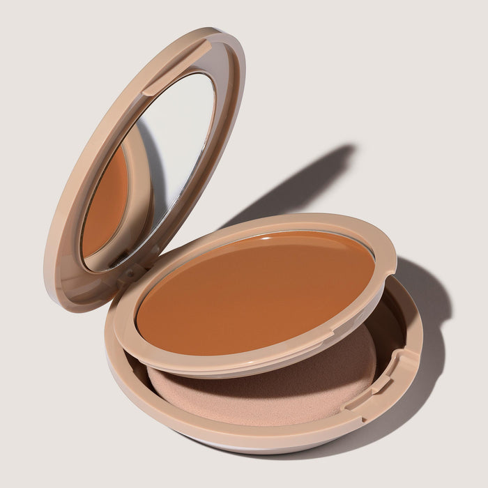 An open FlexShade Foundation by No Makeup Makeup compact in Golden Tan showing the sponge compartment