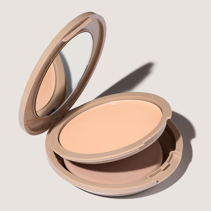 An open FlexShade Foundation by No Makeup Makeup compact in Porcelain showing the sponge compartment