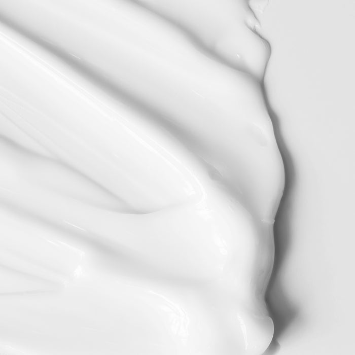 Luxurious white cream swatch with smooth, glossy texture for all skin types, showcasing rich moisturizing formula.