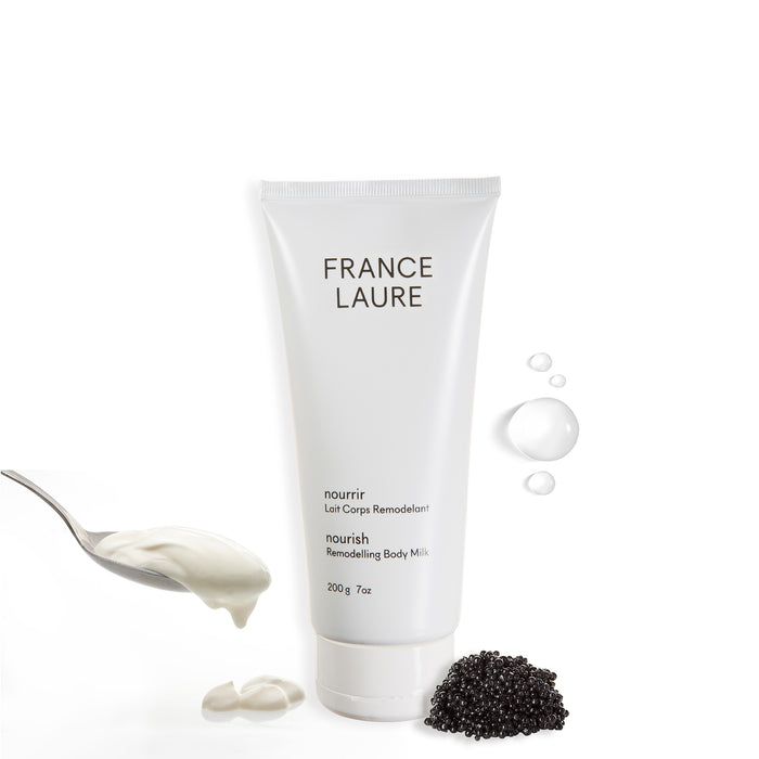 France Laure Nourish Remodelling Body Milk tube with creamy texture swatch, caviar pearls, and hydration droplets on white background