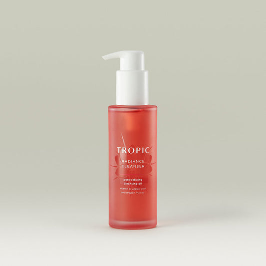 Tropic Radiance Cleanser pore-refining cleansing oil. Contains Vitamin C, azelaic acid and dragon fruit oil.

White pump dispenser. Pink glass bottle with floral embossed design behind white text.