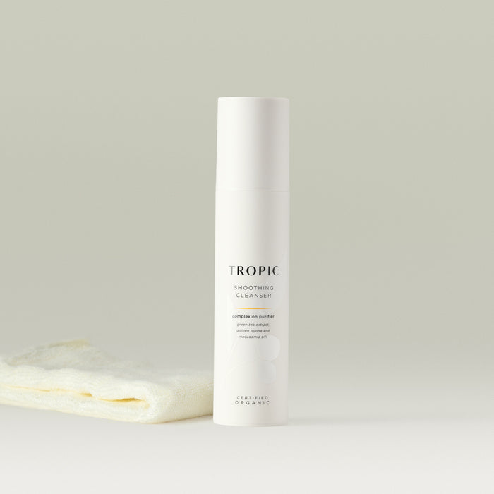 Tropic Smoothing Cleanser complexion purifier 120ml with bamboo face cloth.
Contains green tea extract, golden jojoba and macadamia oils. Certified Organic. White tube with white lid. Leaf design features behind black text.
