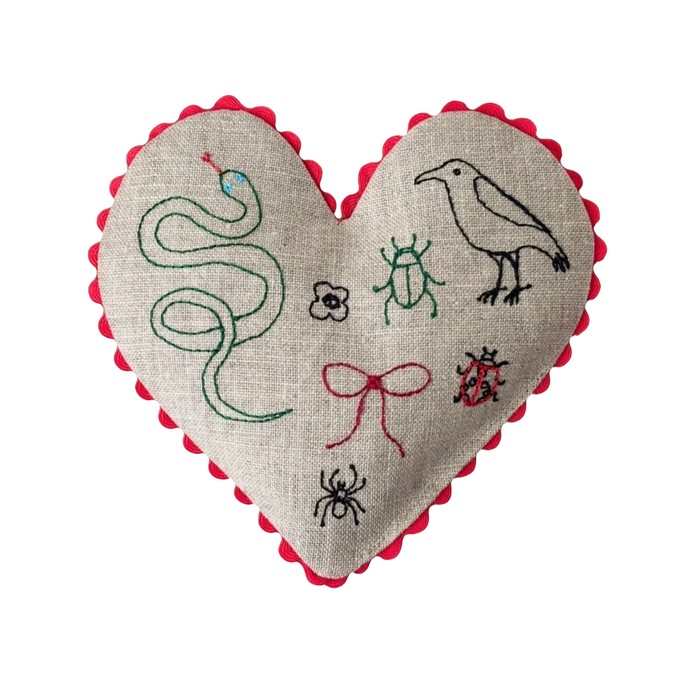 Linen heart sachet with red scalloped edge and stitched snake, bugs, and bird