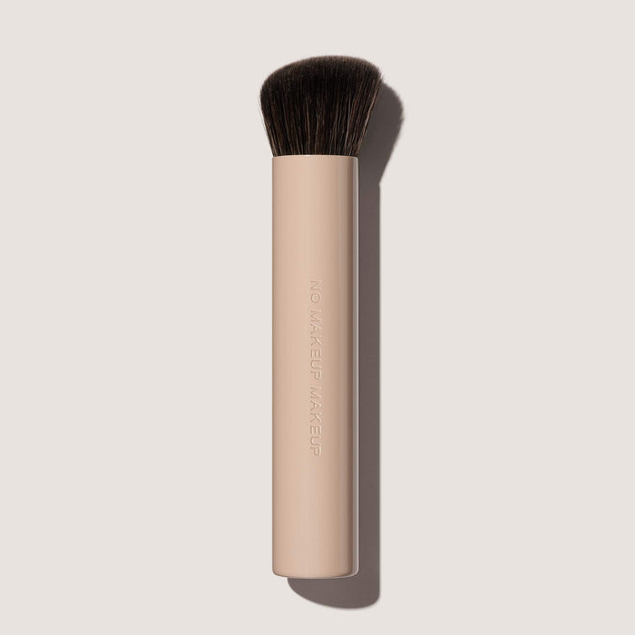 A FlexShade Foundation by No Makeup Makeup brush on an off-white background
