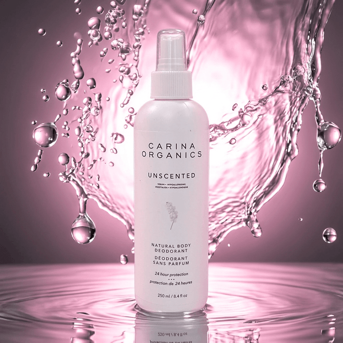 Carina Organics unscented deodorant bottle with water droplets on a pink background